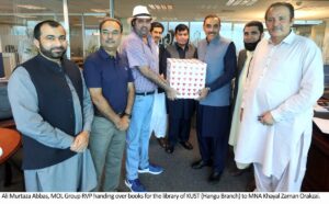 Ali Murtaza Abbas, MOL Group RVP handing over books for the library of KUST (Hangu Branch) to MNA Khayal Zaman Orakzai.