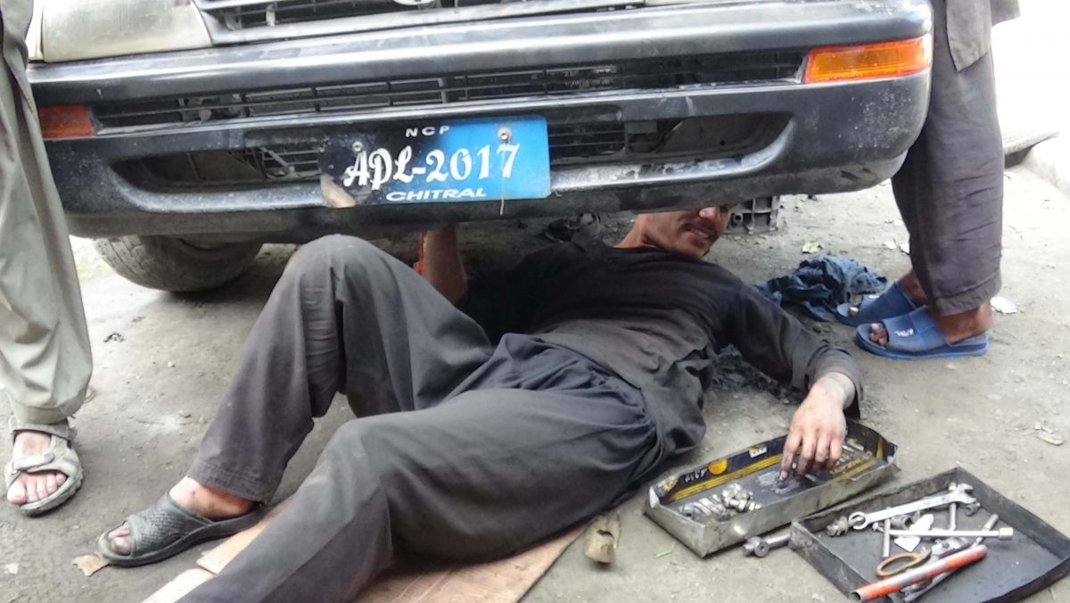 Children working in Chitral auto repair shops without safety equipment