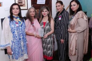 Presenting Sheema Kermani with a shield
