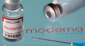 FILE PHOTO: Vial labelled "Moderna coronavirus disease (COVID-19) vaccine" placed on displayed Moderna logo is seen in this illustration picture