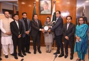 Dr Zahid Hasan Ansari Presents Shield to Minister Shaheena Sher Ali at World Hemophilia Day Seminar