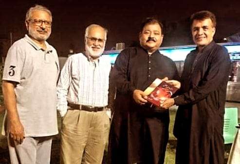 Justice Tauqeer A. Khan presenting his poetry “Hurf Hurf Ishq”&”Manzil k Nishaan Dhondta Hun” to Syed Turab Shah.
