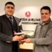 Muhammad Umar Khan presenting the Turkish airlines souvenir to Syed Tarab Shah