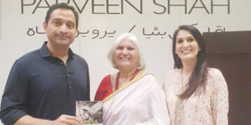 Parveen Shah is presenting her book  “AMMA KI BITYA” to Khurram Sher Zaman of Pakistan Tehreek-e-Insaf.