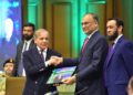 Prime Minister being presented a book on one-year performance of the government by Prof Dr Ahsan Iqbal