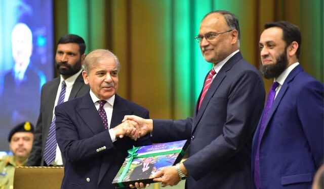 Prime Minister being presented a book on one-year performance of the government by Prof Dr Ahsan Iqbal