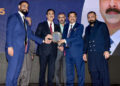 Dr. Mirza Ikhtiar Baig receiving Discon’25 from Yousuf Raza Gilani