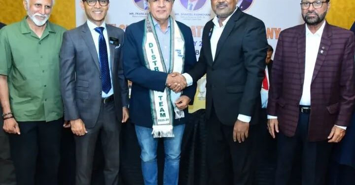 District Governor 3271 Shakeel Qaim Khani is presenting the Rotary District Team Badge to Rotarian Syed Turab Shah.