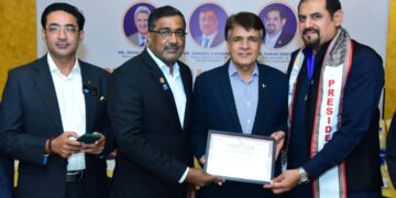 District Governor 3271 Shakeel Qaim Khani is presenting the Rotary District Team Badge to Rotarian Syed Turab Shah.