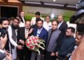 Kaukab Iqbal, presents a bouquet to Syed Mustafa Kamal