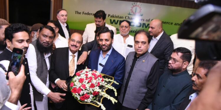 Kaukab Iqbal, presents a bouquet to Syed Mustafa Kamal