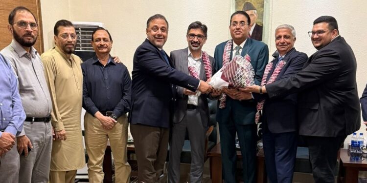 President of SITE Association of Industry Karachi, presents a bouquet to the newly elected President Rehan Hanif,