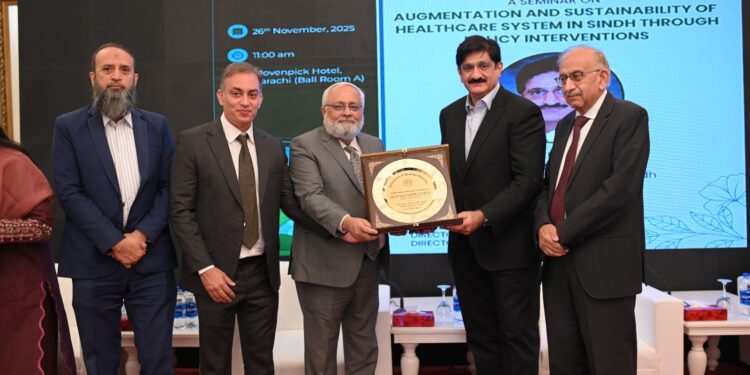 Professor Sarosh Lodhi, Chairman CIEC, presents a shield to Chief Minister Sindh Syed Murad Ali Shah during a seminar organized by the Sindh Higher Education Commission.