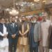 A group photo featuring distinguished personalities from the community alongside senior journalist Sirajuddin Amjadi at the wedding reception (Walima)