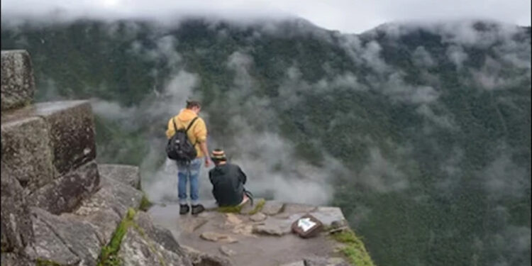 Tourist miraculously survives 130-foot cliff fall while taking selfie.