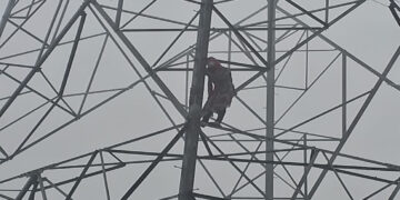 Girl climbs high voltage tower for love.
