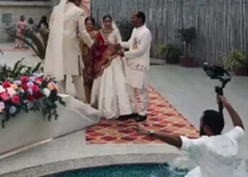 Wedding photo shoot, photographer falls into swimming pool.