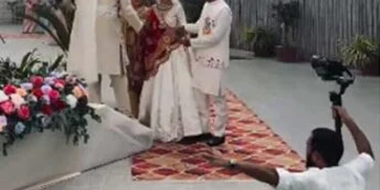 Wedding photo shoot, photographer falls into swimming pool.