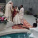 Wedding photo shoot, photographer falls into swimming pool.