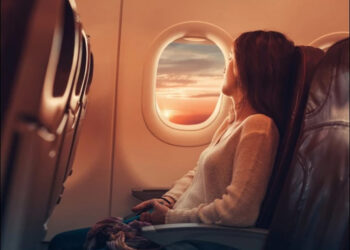 Why are window curtains removed before a plane lands?