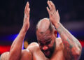 Boxer’s wig ripped off during fight.