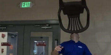 The unique feat of balancing a chair on the chin.