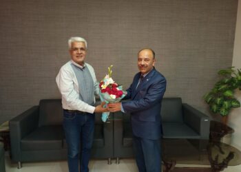 Syed Turab Shah Presenting flower bouquet to Group Capt (R) Mohammed Farhan Ibrahim.
