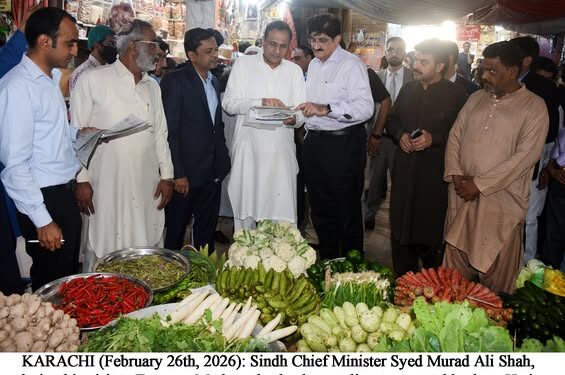 Syed Murad Ali Shah, during his visit to Empress Market, checks the rate list at a vegetable shop.