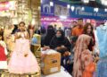 JDC welfare Foundation Pakistan General Secretary Zafar Abbas with others present clothes  to the Children during  Free Eid  bazaar under the title of the “Maa hum bhi Eid Manyen gay” 