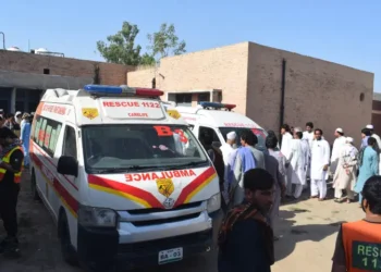 Security forces and rescue teams at the scene of twin vehicle explosions in Bannu
