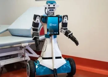 Humanoid healthcare robot assisting a patient in a hospital ward in Milan