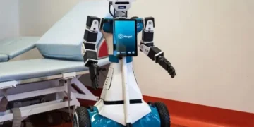 Humanoid healthcare robot assisting a patient in a hospital ward in Milan