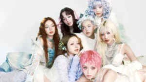 XG girl group performing in neon outfits with synchronized choreography on stage