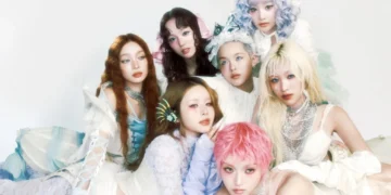XG girl group performing in neon outfits with synchronized choreography on stage