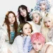 XG girl group performing in neon outfits with synchronized choreography on stage