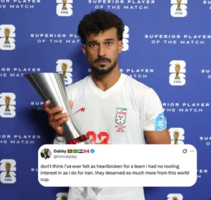 Iran defender Ramin Rezaeian holding the Player of the Match award after Iran's elimination from the FIFA World Cup.