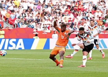 Germany players celebrating a late goal against Ivory Coast in World Cup match.