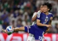 Japan football players celebrating goals against Tunisia in World Cup Group F match.