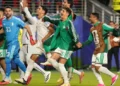 Algeria players celebrating after scoring a late winning goal against Jordan in World Cup match