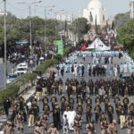 Sindh Police officers monitoring security arrangements during Ashura processions in Karachi.