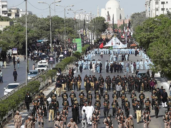Sindh Police officers monitoring security arrangements during Ashura processions in Karachi.