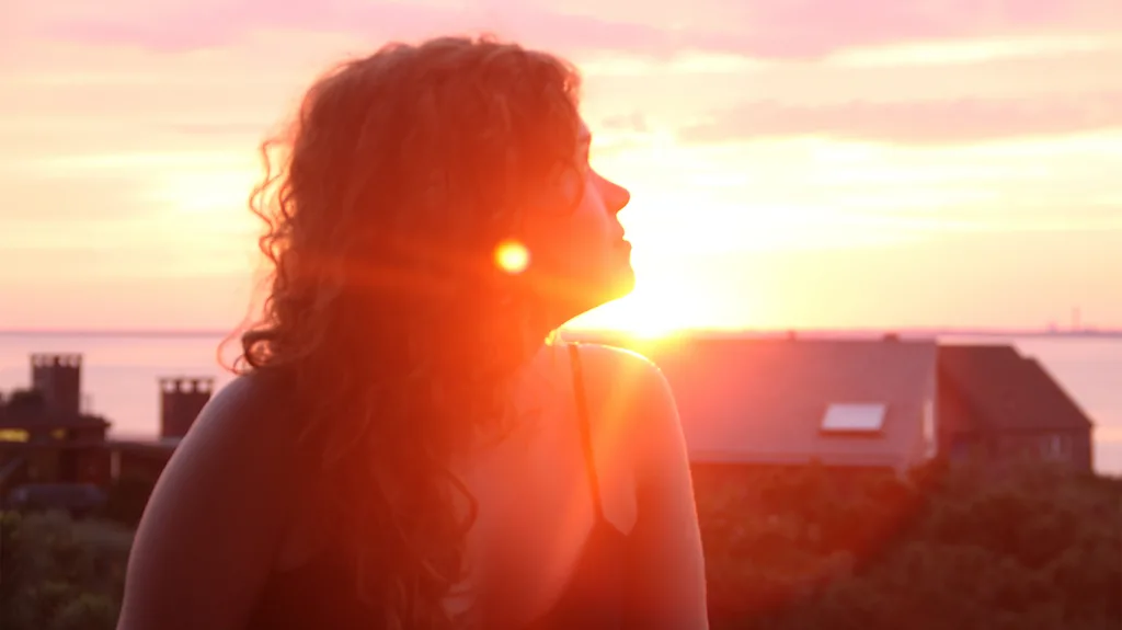 Golden sunset over a natural landscape representing mood, sleep and mental health benefits.