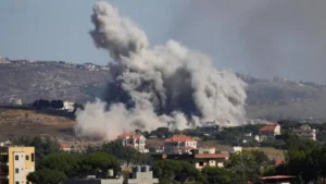 Aerial view of damaged buildings and smoke in southern Lebanon amid Israel Hezbollah ceasefire claims and ongoing strikes.