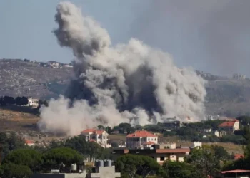 Aerial view of damaged buildings and smoke in southern Lebanon amid Israel Hezbollah ceasefire claims and ongoing strikes.