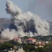 Aerial view of damaged buildings and smoke in southern Lebanon amid Israel Hezbollah ceasefire claims and ongoing strikes.