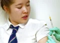Teenage students receiving HPV vaccine as cervical cancer prevention