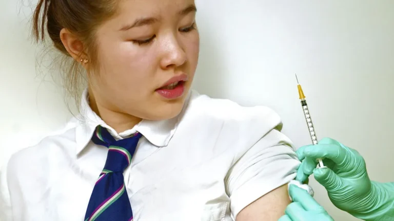 Teenage students receiving HPV vaccine as cervical cancer prevention