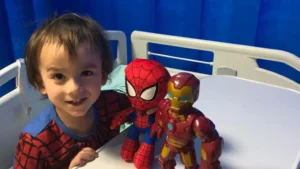 Child undergoing teplizumab infusion in hospital to delay onset of type 1 diabetes.