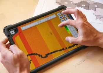 Farmer using digital technology and artificial intelligence tools for modern agricultural planning.