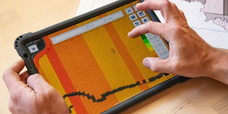 Farmer using digital technology and artificial intelligence tools for modern agricultural planning.